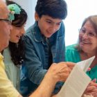 Happy family moments with grandparents and grandchildren enjoying time together indoors.