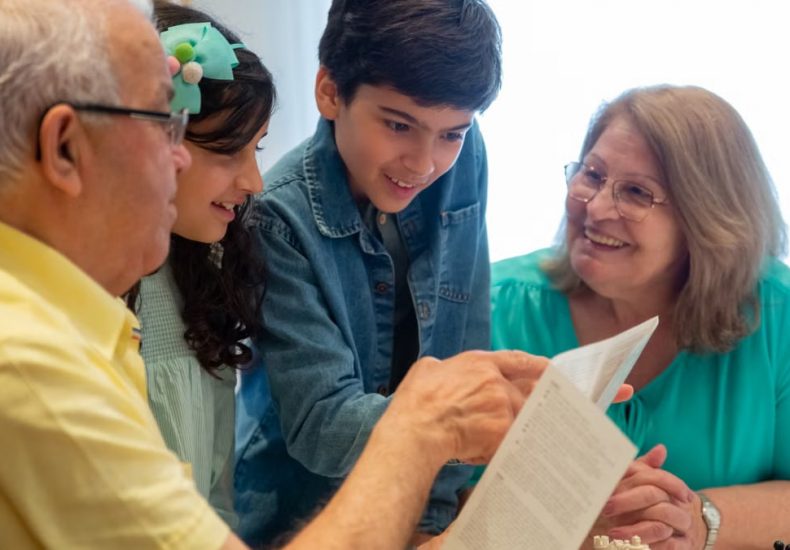 Happy family moments with grandparents and grandchildren enjoying time together indoors.